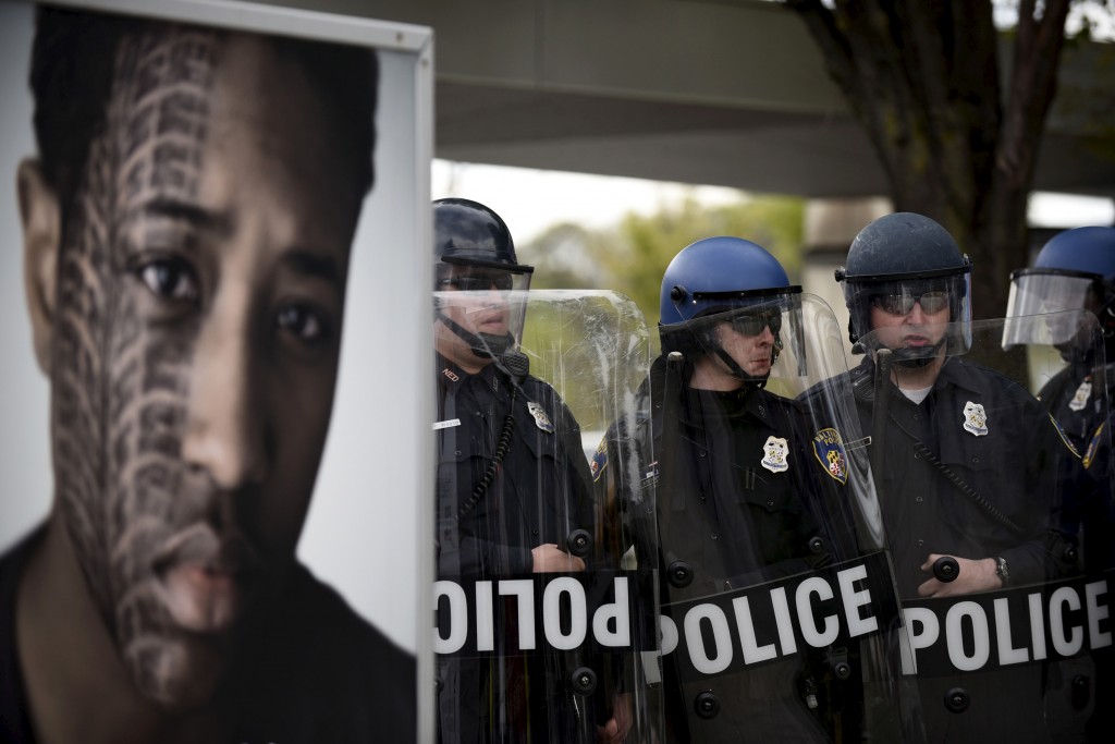 Police form a line during clashes with protesters near Mondawmin Mall after Freddie Gray's funeral in Baltimore April 27, 2015. Seven Baltimore police officers were injured on Monday as rioters threw bricks and stones and burned patrol cars in violent protests after the funeral of Gray, a black man who died in police custody. REUTERS/Sait Serkan Gurbuz - RTX1AJH9